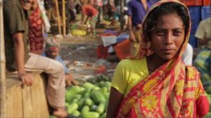 A woman at a market in Bangladesh. A new book shows that the growth of microfinance institutions over two decades in Bangladesh has helped the rural poor diversify their economic activities and boost incomes, lifting some 2.5 million people out of poverty. 